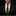 Man wearing a black suit with a gold tie and pocket square against a dark background