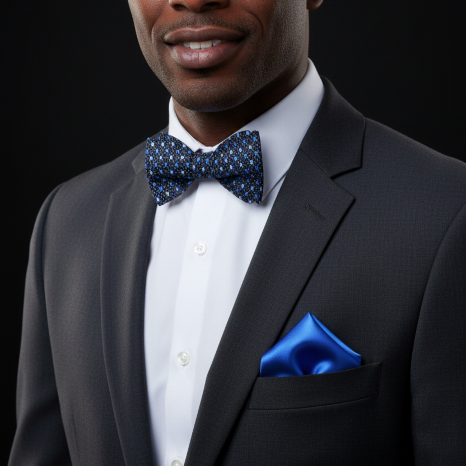 Blue polka dot bow tie and matching pocket square on a mannequin.