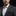 Man wearing a gray suit with a white shirt and patterned pocket square on a black background