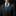 Man wearing a dark gray suit with a green patterned tie and pocket square on a black background