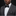 Man wearing a gray suit with a black bow tie and pocket square on a black background