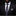 Man wearing a black suit with a patterned tie and pocket square on a dark background