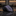 Folded black tie on a dark marble surface with blurred background