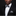 Man wearing a black tuxedo with a white shirt, black bow tie, and matching pocket square against a dark background.