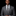 Man wearing a gray suit with a patterned tie and pocket square on a black background