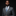 Man wearing a gray suit with a patterned tie and pocket square on a black background