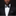 Man wearing a black suit with a white shirt and bow tie on a dark background