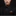 Man wearing a black suit with an orange pocket square against a dark background