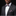 Man wearing a black suit with a plaid bow tie and pocket square on a black background