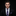Man wearing a dark suit with a floral tie and pocket square on a black background