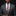 Man wearing a gray suit with a red and black plaid tie and pocket square on a black background