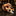 A rolled necktie with a bold abstract swirl pattern in orange, black, white, and yellow, displayed on a dark marble surface with a blurred luxury interior background.