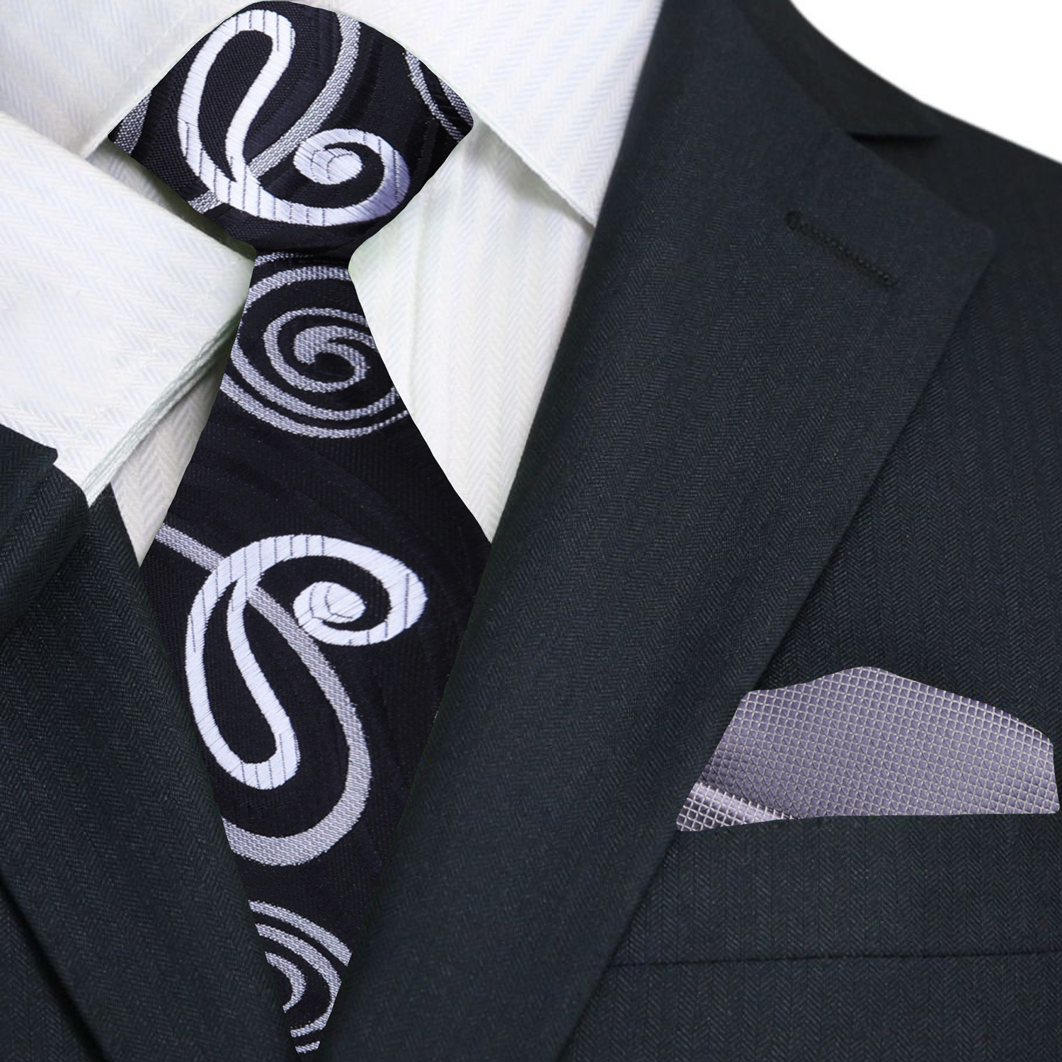 Black suit with a black and grey patterned tie and grey pocket square