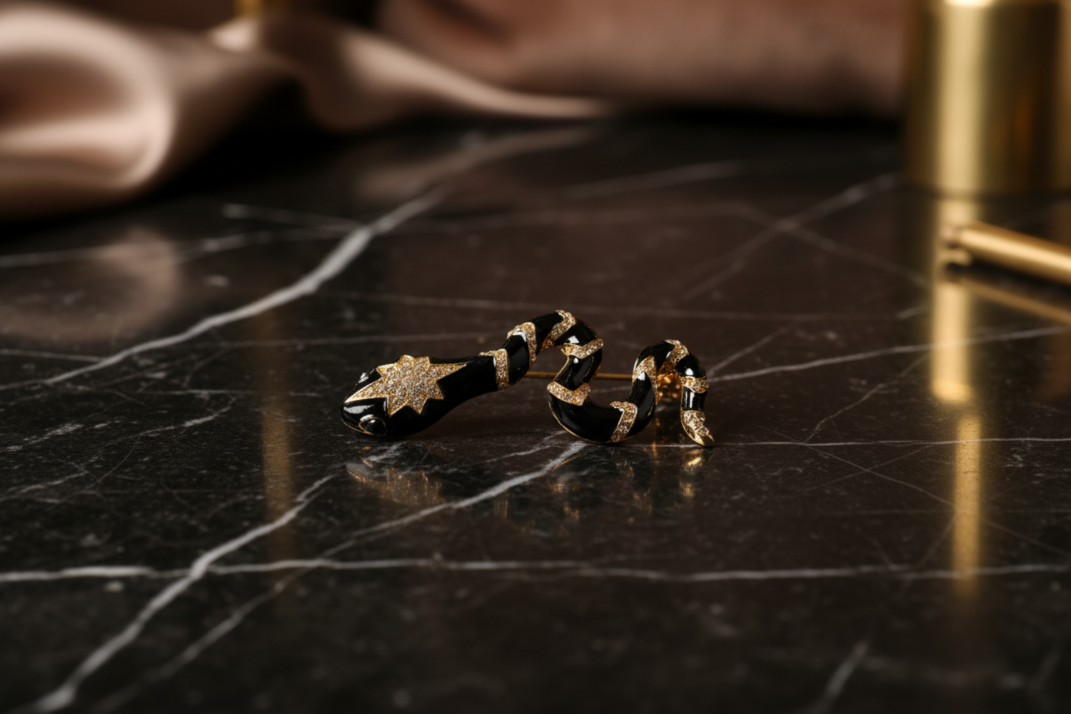 a black and gold snake lapel pin
