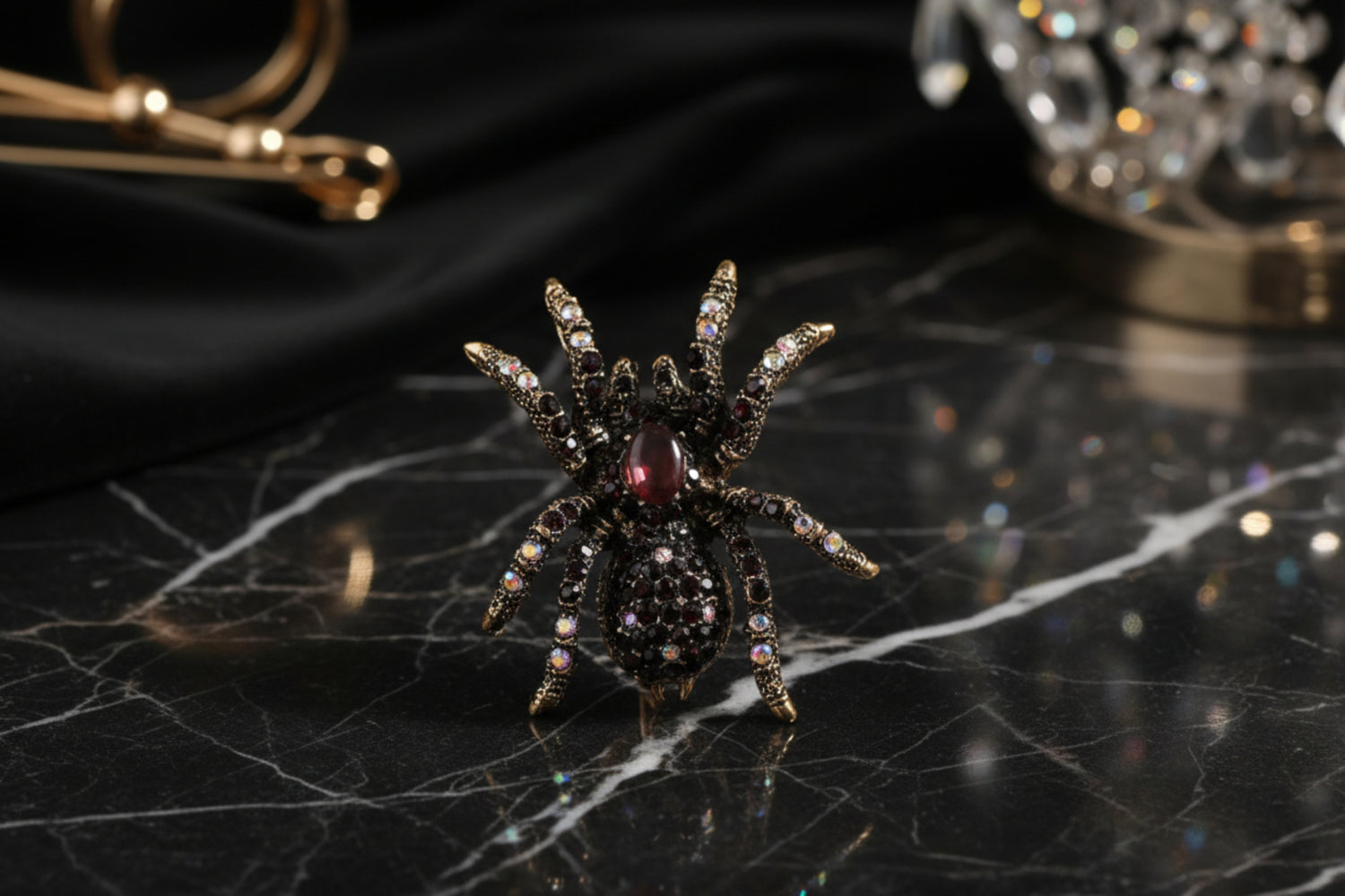 A decorative spider-shaped lapel pin with a combination of metallic and gemstone finishes displayed against a wooden backdrop.