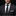 Man wearing a black suit with a white shirt and black polka dot tie on a dark background