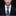 Man wearing a black suit with a colorful tie featuring game-themed designs.