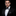 Man wearing a black tuxedo with a bow tie on a black background