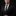 Man wearing a black suit with a patterned tie against a dark background