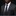 Man wearing a gray suit with a black polka dot tie and pocket square against a dark background