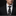 Man wearing a black suit with a white floral tie against a dark background