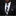 Man wearing a black suit with a floral tie and pocket square against a dark background