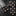 Black tie with beige polka dots on a wooden surface