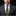 Man wearing a dark suit with a yellow striped tie on a black background