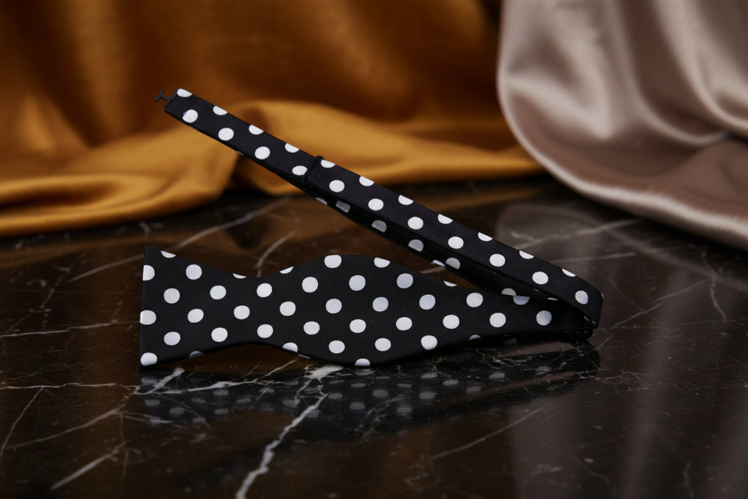 A Black, Light Grey Polka Pattern Self Tie Bow Tie