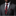 Man wearing a gray suit with a red floral tie and pocket square on a black background