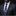 Man wearing a dark suit with a blue and black camouflage tie and pocket square.