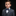 Young boy in a gray suit with a blue bow tie on a black background