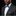 Man wearing a black suit with a blue and gray patterned bow tie and pocket square on a black background
