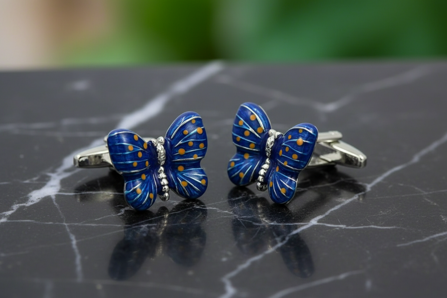 a small pair of butterfly cufflinks
