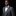 Man wearing a gray suit with a blue bow tie and pocket square on a black background