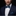 Man wearing blue grid bow tie and square on suit