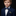 Young boy in a formal outfit with a blue bow tie on a black background