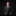 Young boy in a formal gray suit with a patterned tie against a black background
