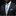 Man wearing a dark suit with a patterned blue tie and pocket square on a black background