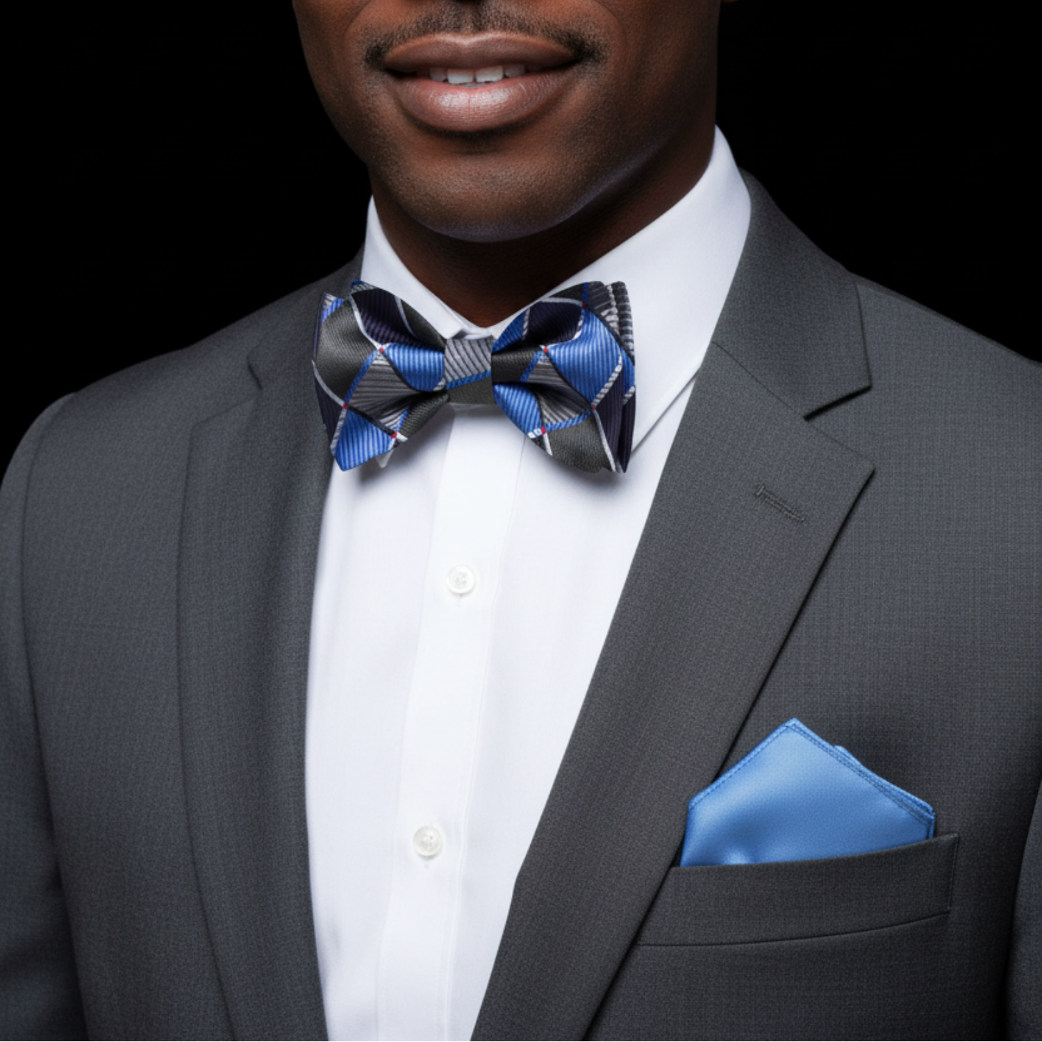 Man wearing grey, black and blue geometric squares bow tie and blue square