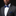 Man wearing a gray suit with a white shirt and blue bow tie and pocket square against a black background