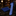 A blue patterned necktie and matching blue pocket square displayed on a dark marble surface in a refined interior setting.