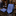 A blue patterned necktie and matching pocket square displayed on a dark marble surface, with a blurred suit mannequin and store interior in the background.