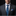 Man wearing blue leaves tie and accenting plaid square on suit