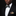Man wearing a black suit with a patterned bow tie and pocket square on a dark background
