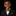 Young boy in a suit with a yellow and blue bow tie on a black background