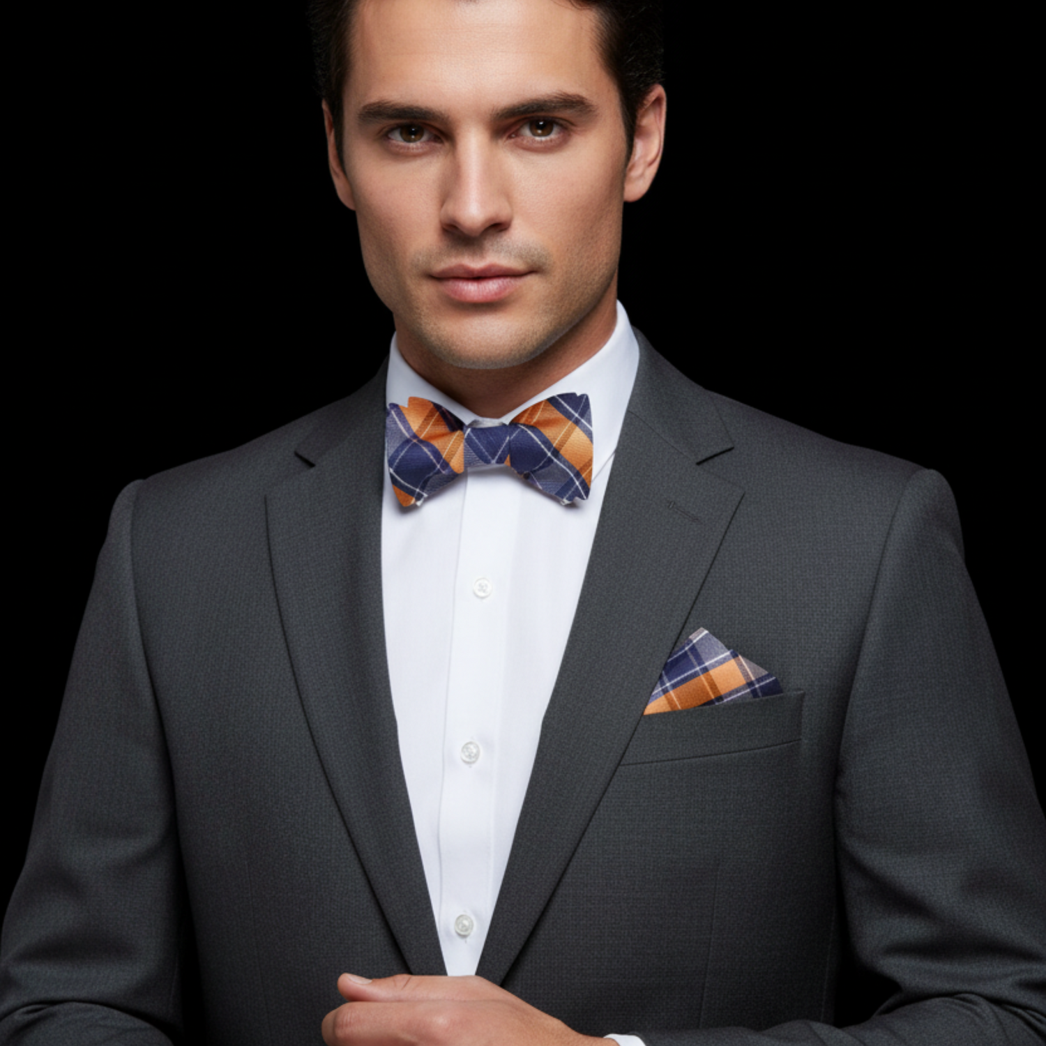 Man wearing orange and dark blue plaid bow tie and square