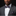 man wearing orange blue plaid bow tie and square on suit