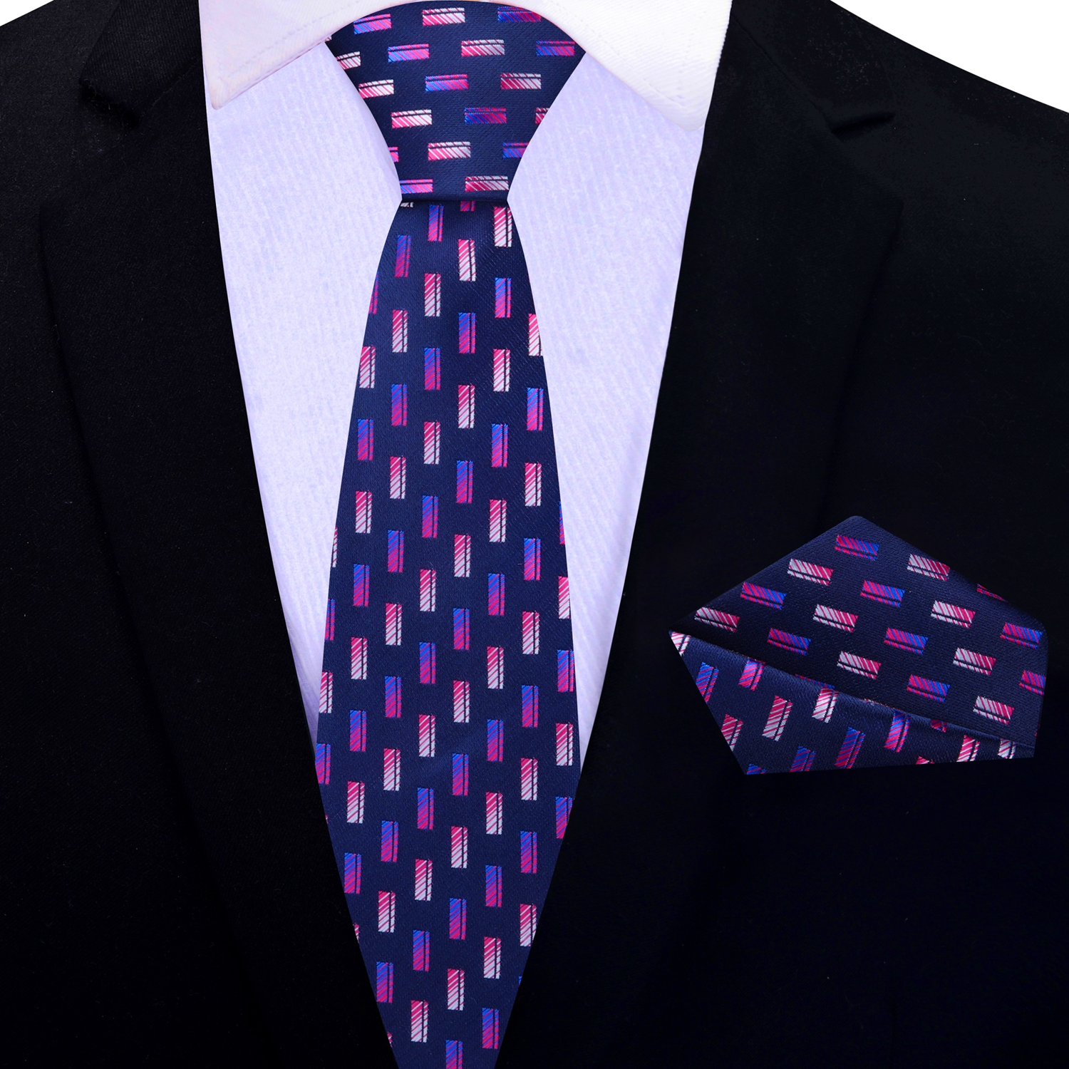 A necktie with a geometric check pattern in blue and pink shades, displayed on a marble surface with a white dress shirt and green foliage in the background.