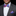Man wearing a gray suit with a colorful bow tie and pocket square against a black background